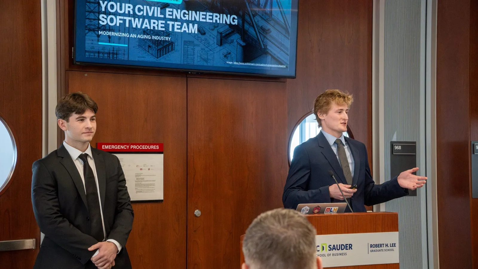 Zander Dent presenting at a podium beside a slide reading Your Civil Engineering Software Team