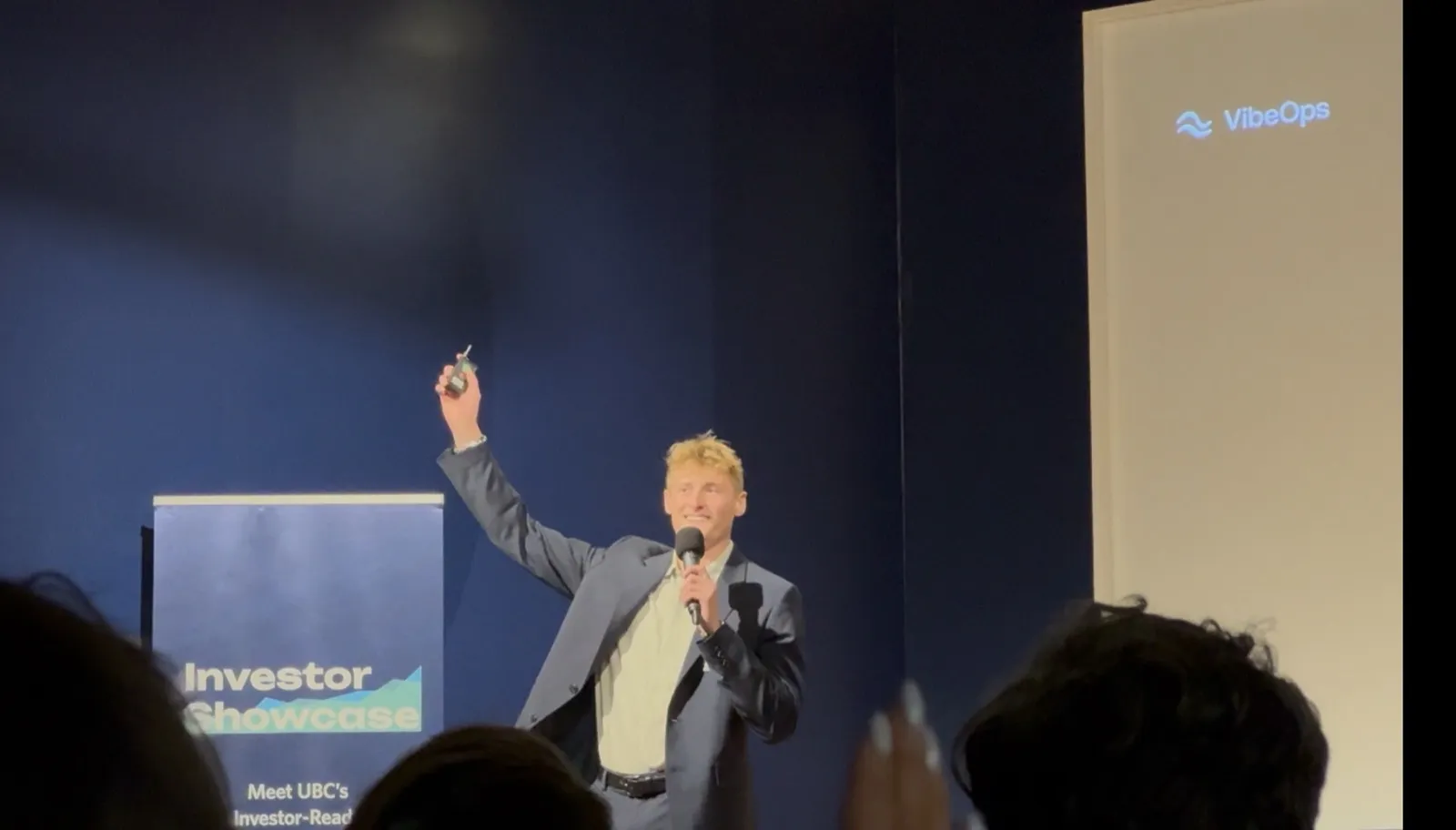 Zander Dent on stage with a microphone at the Investor Showcase