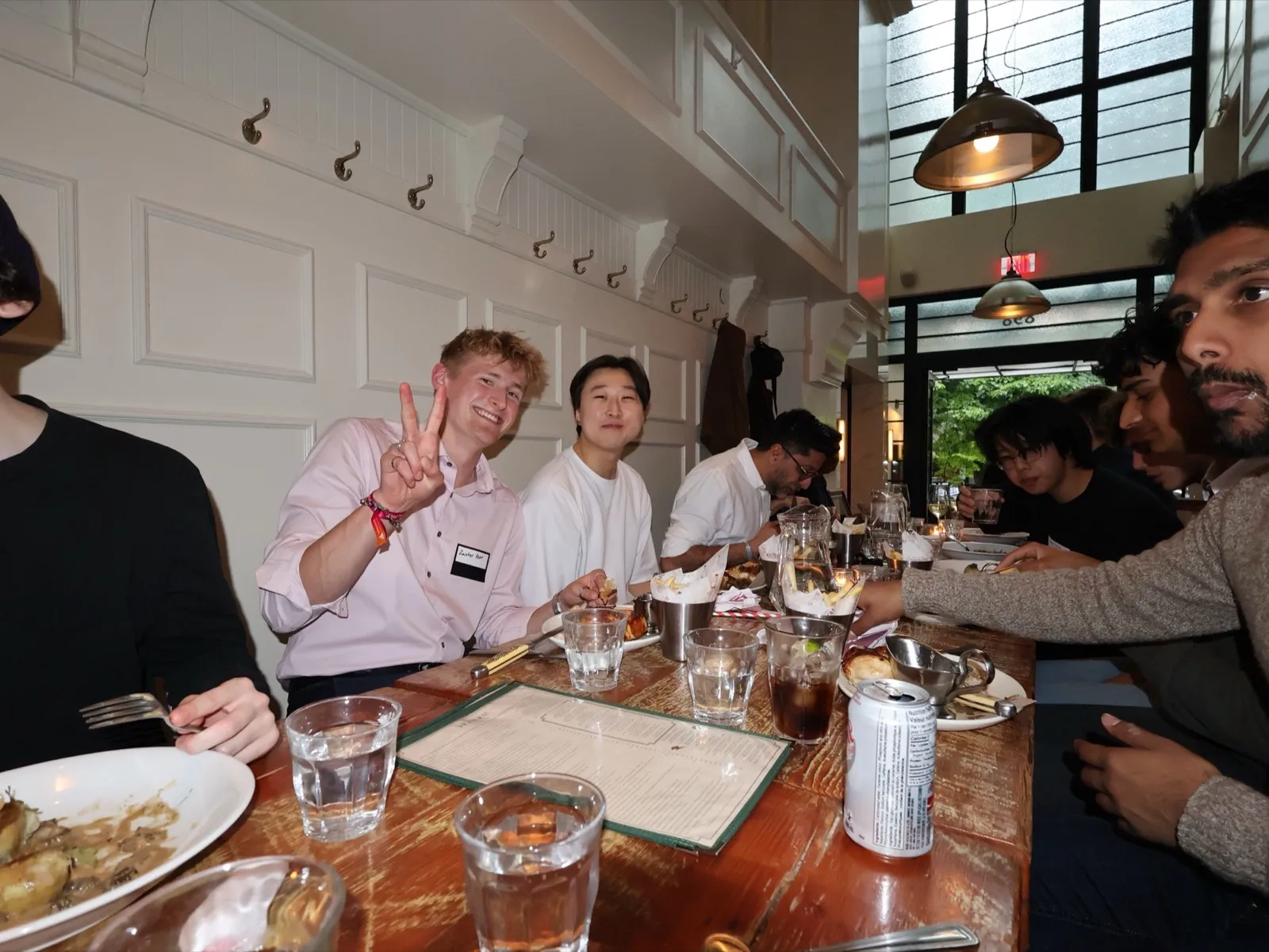 Zander Dent at a long restaurant table with a group